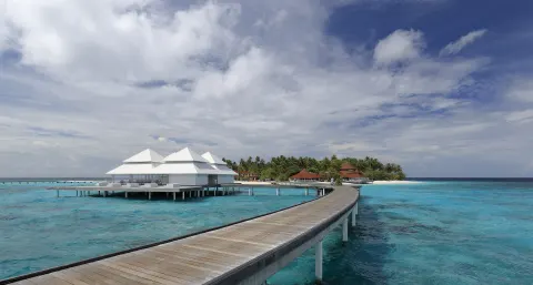 Overwater villas and a jetty above the Maldives lagoon